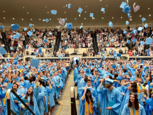 students throwing graduation caps